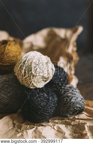 Cozy Balls Of Yarn For Hand Knitting With Dry Oak Leaf On A Dark Background. Autumn Background For H