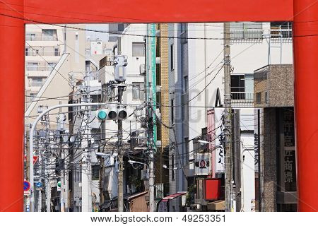 Electrical Lines and Street Light Seen Through Torii Gate