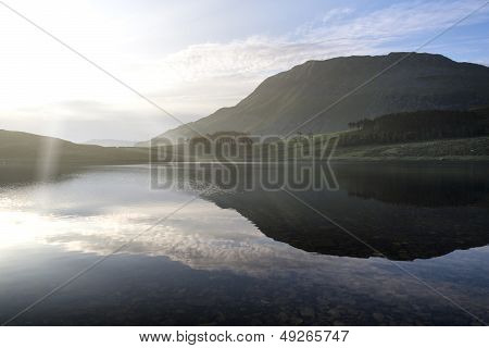 Beautiful Sunrise Mountain Landscape Reflected In Calm Lake