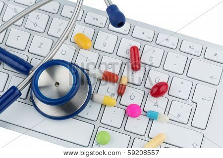 tablets on keyboard symbol photo for online pharmacies and drug costs