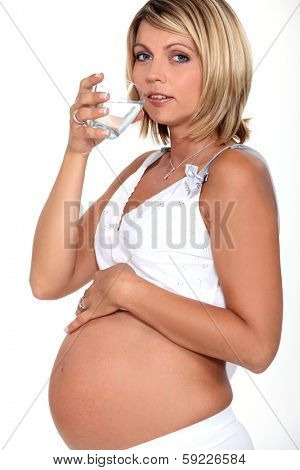 Pregnant woman drinking glass of water