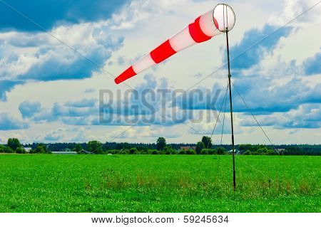 Striped Windsock In A Green Field