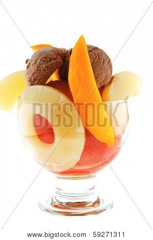 fresh raw  tropical fruits with chocolate ice cream in big glass isolated on white background