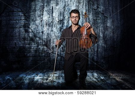 the violinist: Musician playing violin on dark grunge background
