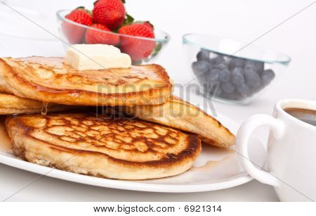 Stack Of Pancakes With Butter And Slathered With Syrup
