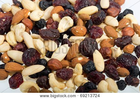 mixed nuts and dried fruits isolated on white background