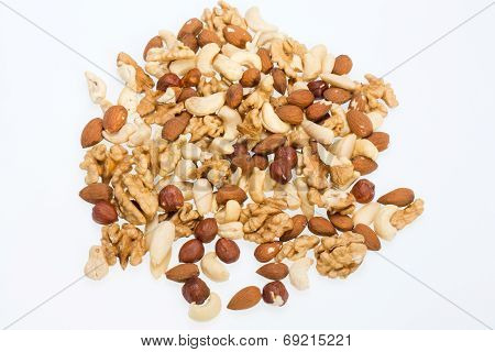mixed nuts - hazelnuts walnuts cashews pine nuts isolated on white background