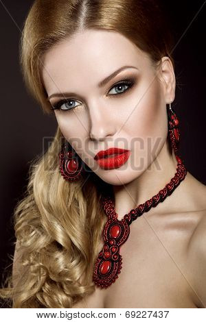 Beautiful blonde woman with evening make-up and red lips.