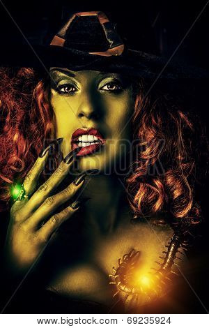 Close-up portrait of a fairy wicked witch in the wizarding lair. Magic. Halloween.