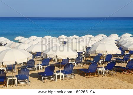 Sandy beach with white parasols and sunbeds Kathisma Lefkada 