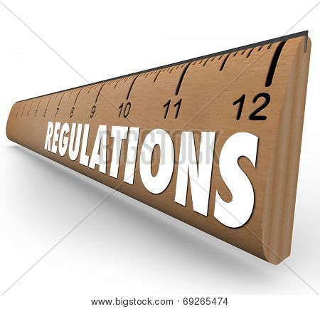 Regulations word on a wooden ruler measuring if you are within rules or guidelines for size, length or other standard