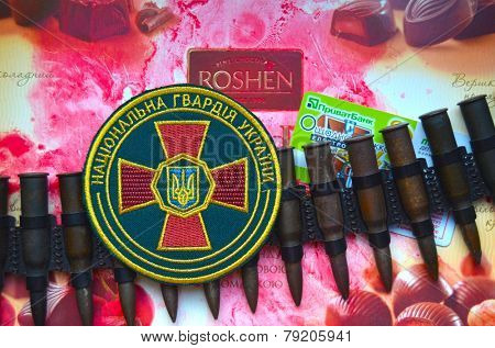 Kiev,Ukraine.Dec 20.Illustrative editorial.Chevron of Ukrainian National Guard.With logo Roshen Inc. Trademark Roshen is property of ukrainian president Poroshenko.At December 20,2014 in Kiev,Ukraine 