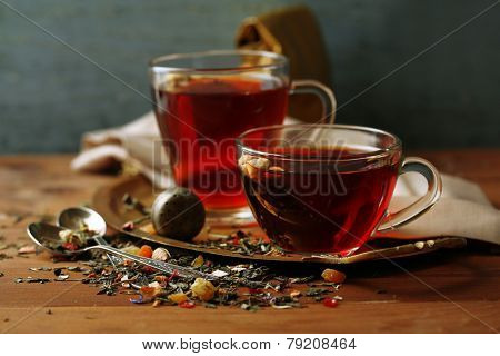 Beautiful vintage composition with herbal tea, on wooden table