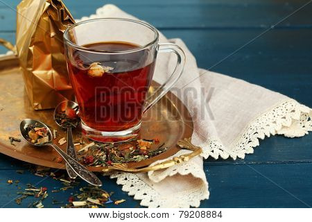 Beautiful vintage composition with herbal tea, on wooden table