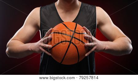 Close up of male basketball athlete gripping the ball