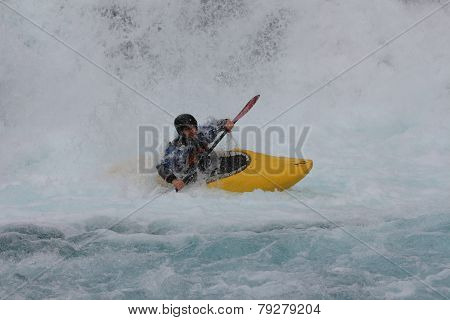 A man is kayaking in Norwegian river.
