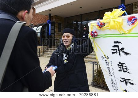 Chinese man with calligraphy banner