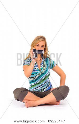 Studio shot of young blone woman with digital camcorder