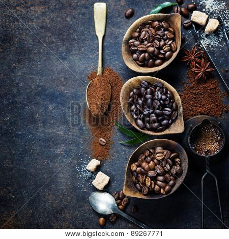 Top view of three different varieties of coffee beans on dark vintage background