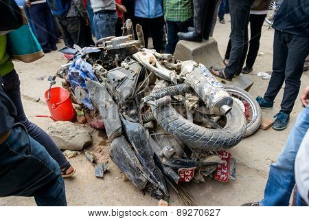 KATHMANDU, NEPAL - APRIL 26, 2015: Two crushed motorbikes next to the collapsed Dharhara tower after the major earthquake on 25 April 2015.