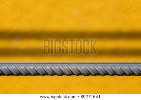Gray Rod Of Fittings On A Yellow Background