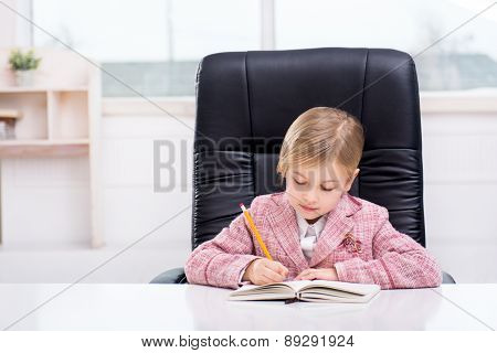 Little cute girl playing role of business woman