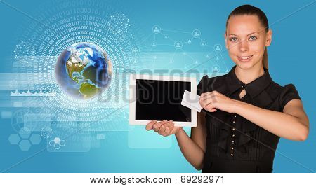Businesswoman holging tablet and card