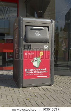 GRONINGEN NETHERLANDS - AUGUST 22 2015: Small waste compactor on the groningen university campus. By compressing its contents the unit gains capacity so it doesn't have to be emptied as often