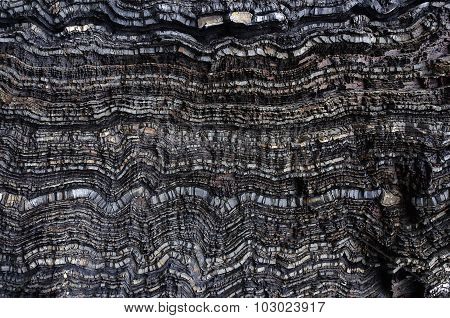 Black Wavy Layers Of Rock