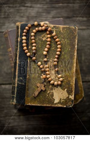 the vintage rosary beads on old book