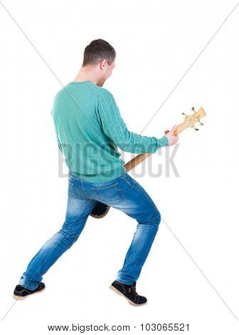 Back view of young man with guitar. Rock star with a musical instrument.  Rear view people collection.  backside view person.  Isolated over white background. Young bass player plays with enthusiasm