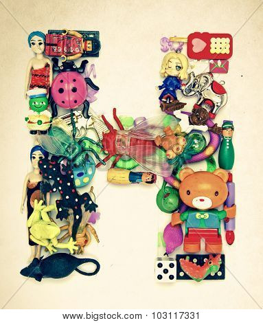 the letter   H made from small toys