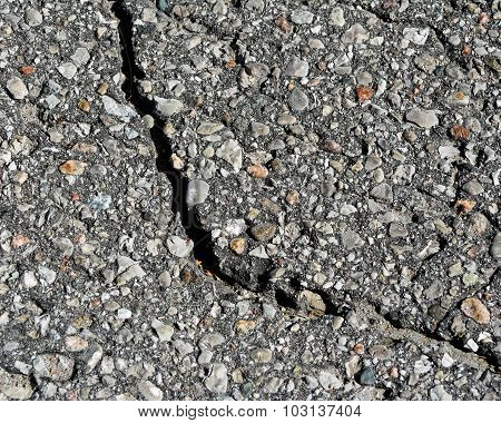 Paved asphalt surface with a large crack
