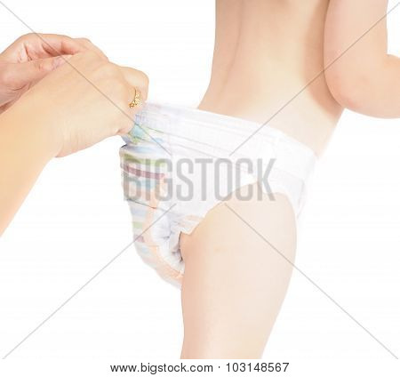 Mother Checking Pull Up Diaper Pants On Restless Toddler Isolated On White
