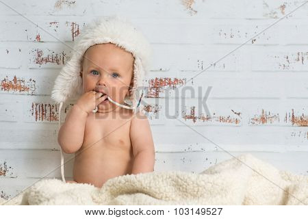 Baby Girl In A Cap Enjoying Warmth Of The Room