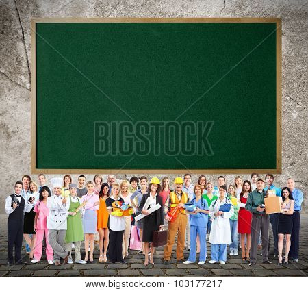 Large Workers People group near blackboard background.