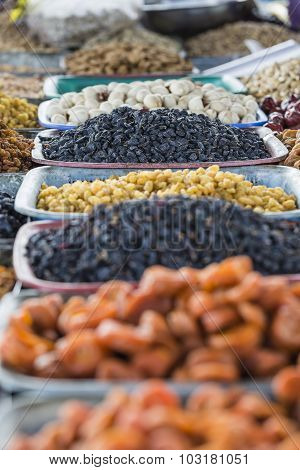 Dry Fruits And Spices Like Cashews, Raisins, Cloves, Anise, Etc. On Display For Sale In A Bazaar In