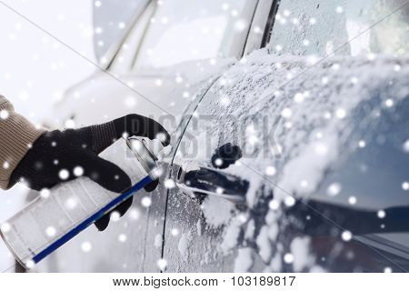 transportation, winter, people and vehicle concept - closeup of man hand with lock door de-icer