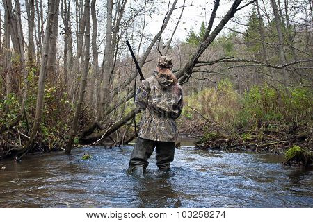 Woman Hunter In Waders On The River