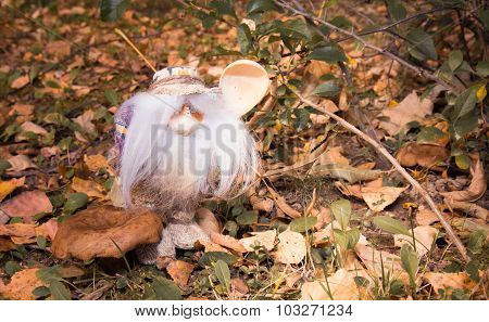 The Magic Little Man With A Wooden Spoon In The Autumn Wood Near A Mushroom