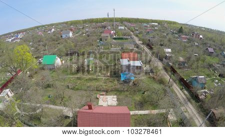 Houses  with gardens in small village at spring sunny day. Aerial view video frame