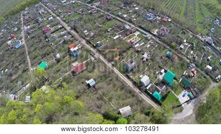Small village among plants at spring sunny day. Aerial view video frame