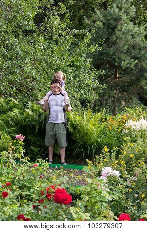 Little Girl On Daddy Shoulders Close His Eyes With Her Hands