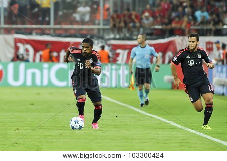 Douglas Costa (l) And Arturo Vidal (r) During The Uefa Champions League Game Between Olympiacos And