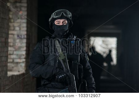Fully equipped military men with automatic weapons playing airsoft strikeball