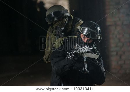 Fully equipped military men with automatic weapons playing airsoft strikeball