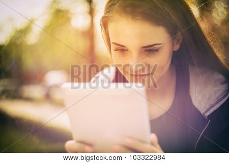Beautiful Girl With Tablet Or Ebook Outdoor
