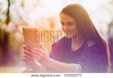 Beautiful Girl With Tablet Or Ebook Outdoor