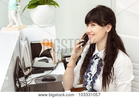 Beautiful girl at the reception answering call