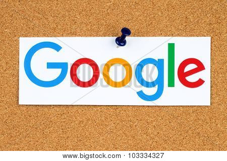 New Google logotype printed on paper cut and pinned on cork bulletin